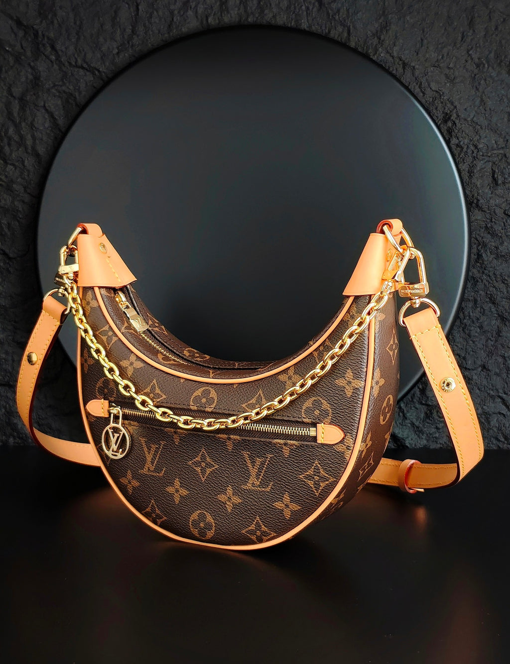 Louis Vuitton hobo bag with monogram canvas, front zip pocket, gold chain and tan strap