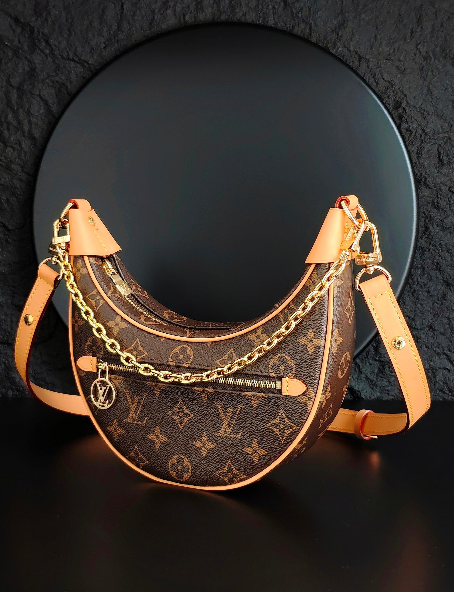 Louis Vuitton hobo bag with monogram canvas, front zip pocket, gold chain and tan strap