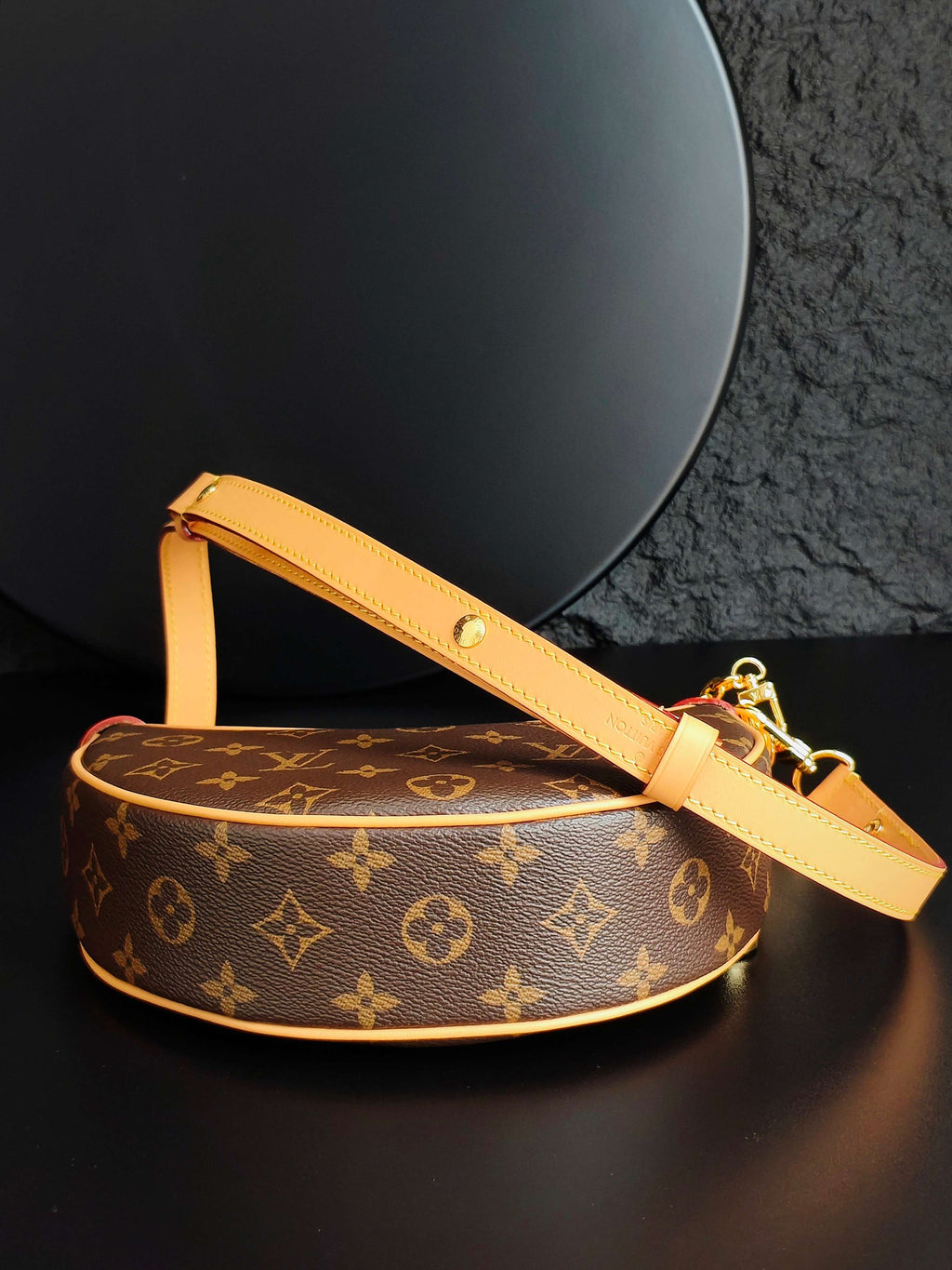 Louis Vuitton round crossbody bag with monogram canvas, tan strap and gold clasp