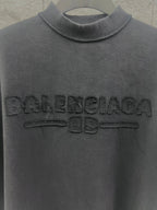 Dark T-shirt collar and large embossed Balenciaga logo on the chest