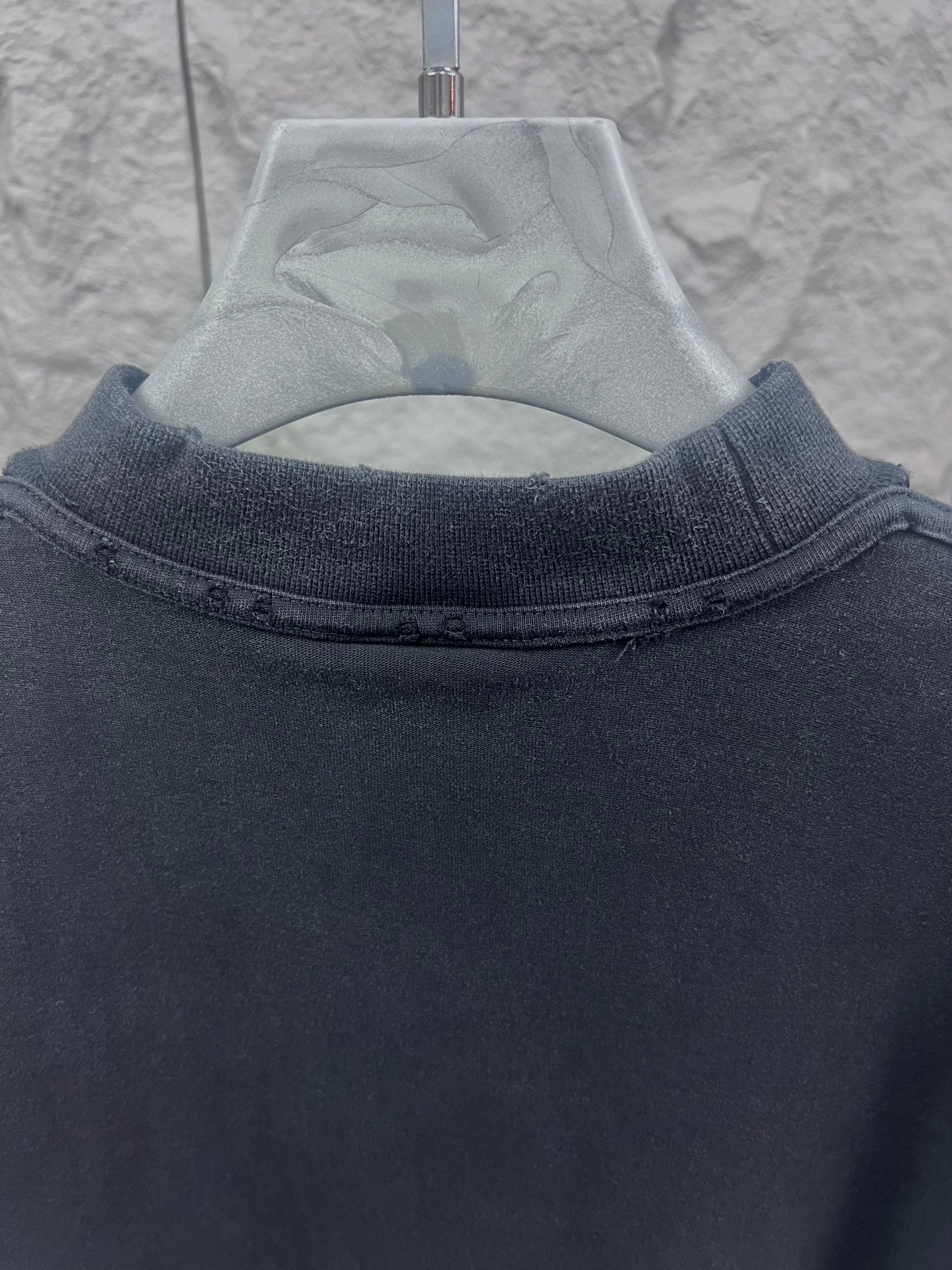 Dark T-shirt neckline and upper back seam detail