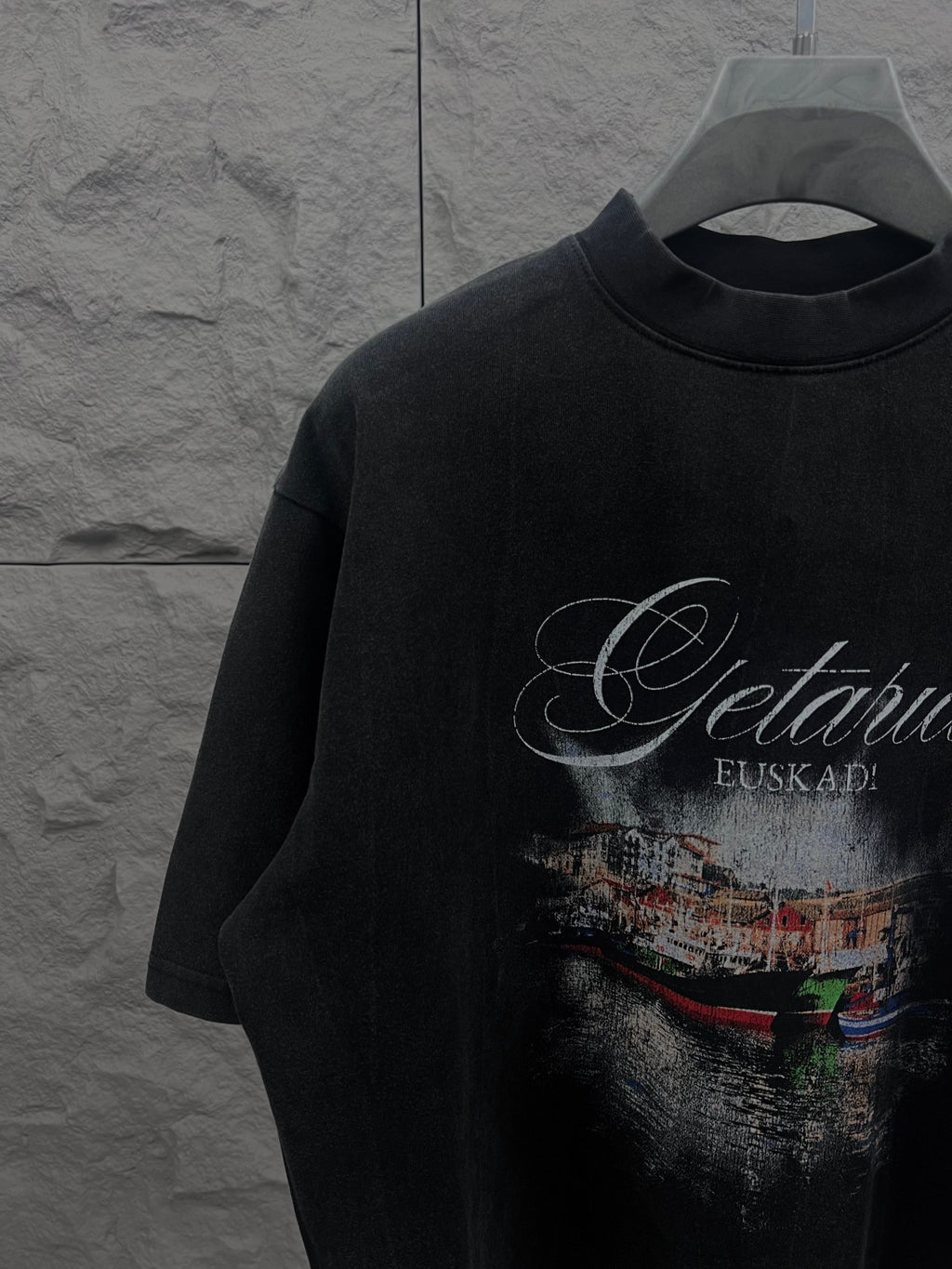 Balenciaga short-sleeve T-shirt in dark color with large front graphic print, close-up