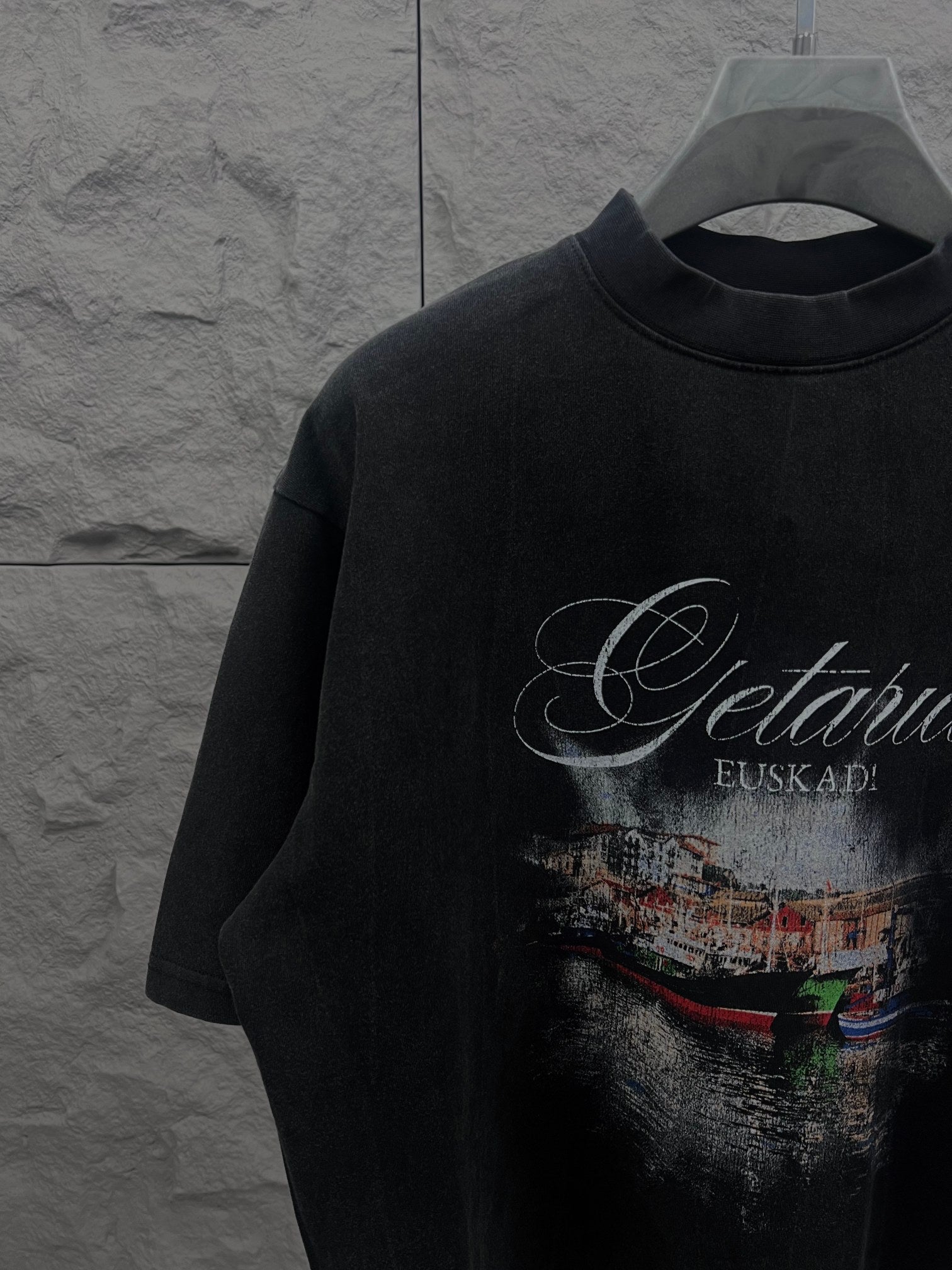 Balenciaga short-sleeve T-shirt in dark color with large front graphic print, close-up