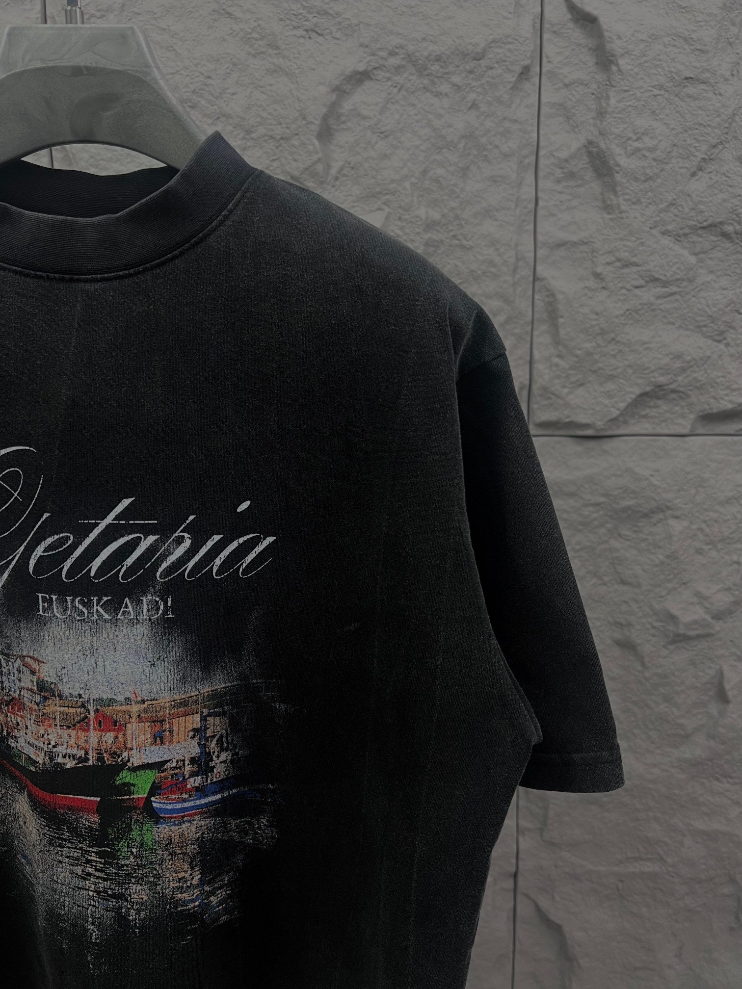 Balenciaga short-sleeve T-shirt in dark color with partial front graphic print, side angle