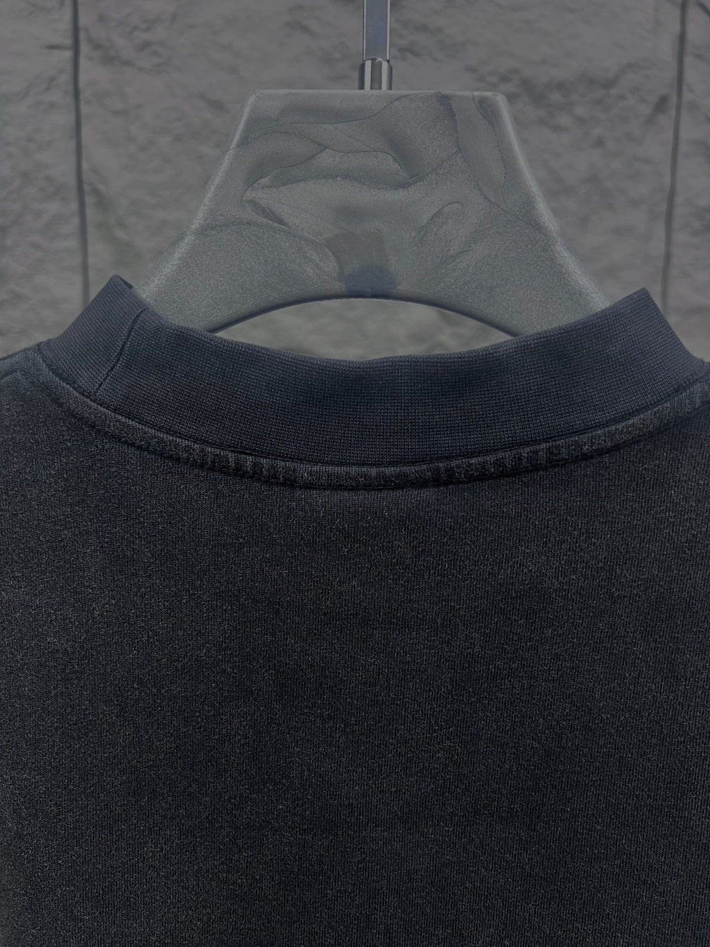 Balenciaga short-sleeve T-shirt, close-up of dark crew collar with visible stitching