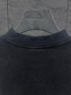 Balenciaga short-sleeve T-shirt, close-up of dark crew collar with visible stitching
