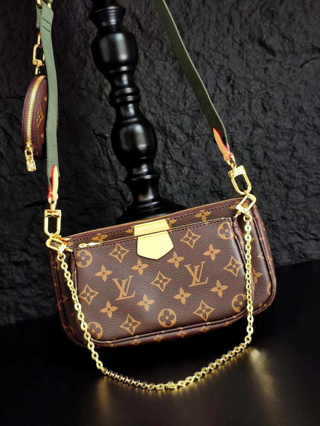 Monogram crossbody bag with gold chain and brown front flap, green strap