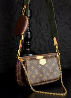 Monogram crossbody bag with gold chain, brown flap and green shoulder strap