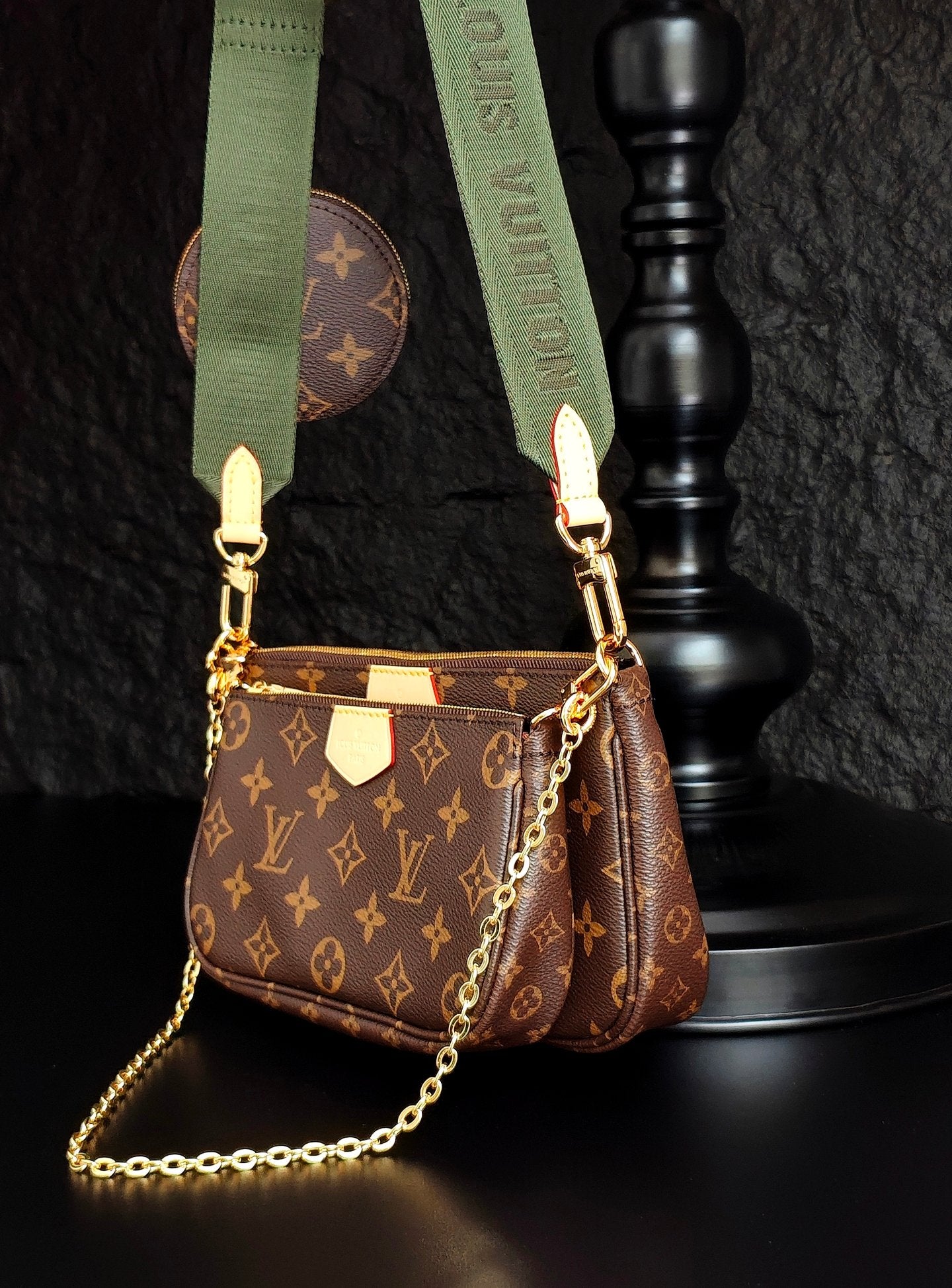Monogram crossbody bag with gold chain, brown zip pocket and green strap