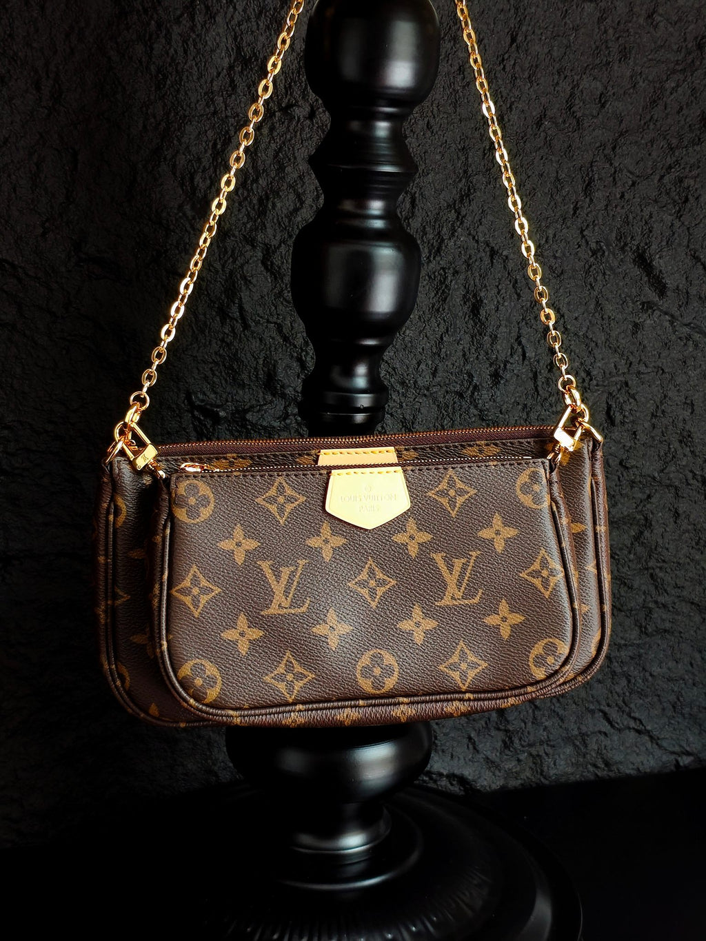 Monogram crossbody bag with gold chain and brown front flap, side view