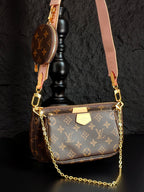 Louis Vuitton crossbody bag with monogram canvas, gold chain strap, top zipper and flap