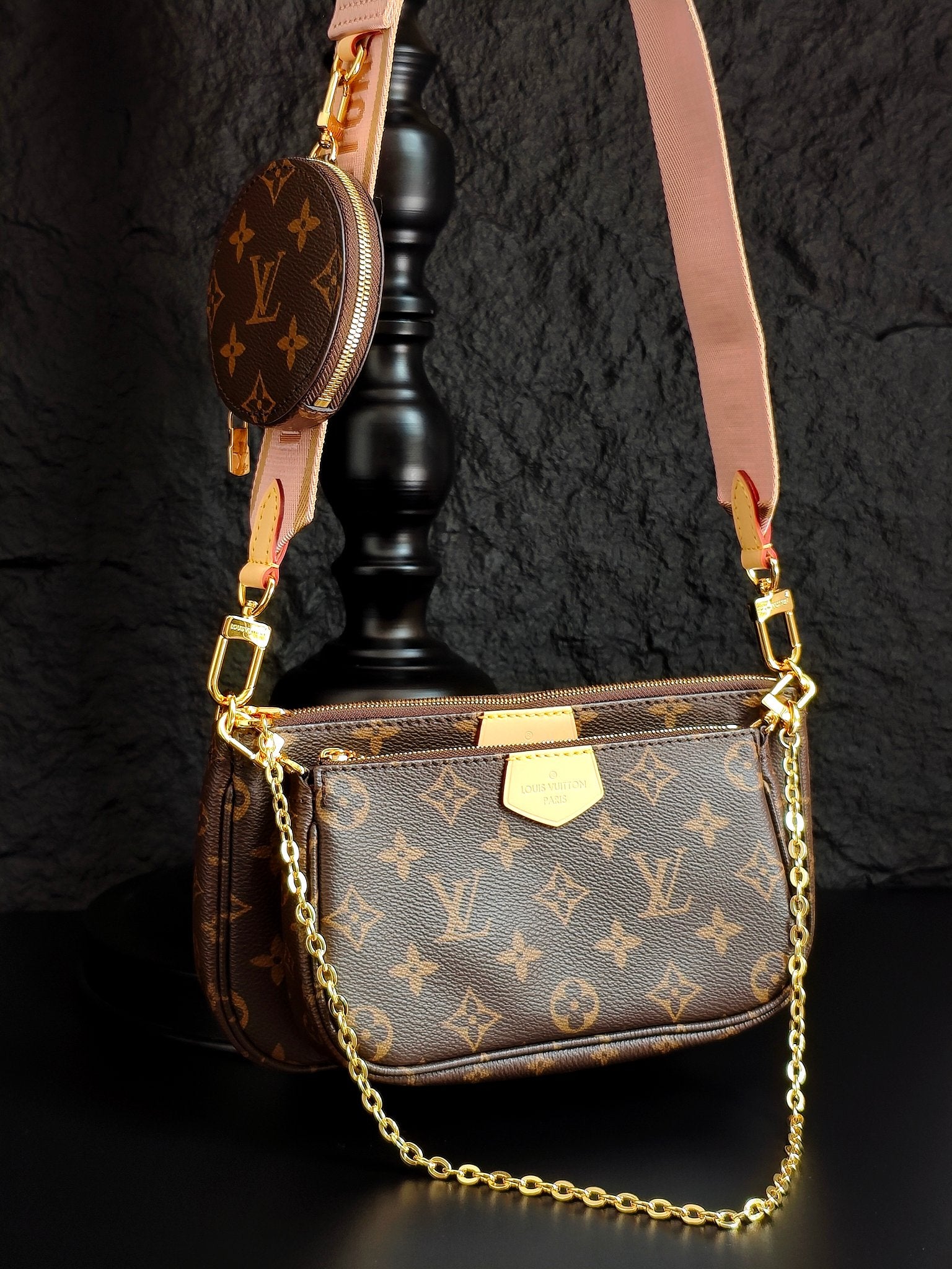 Louis Vuitton crossbody bag with monogram canvas, gold chain strap, top zipper and flap