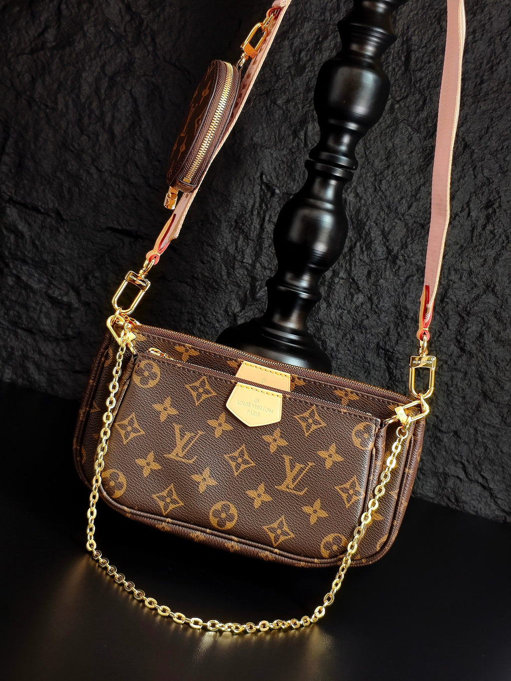 Louis Vuitton crossbody bag with monogram canvas, gold chain strap, and zippered front view