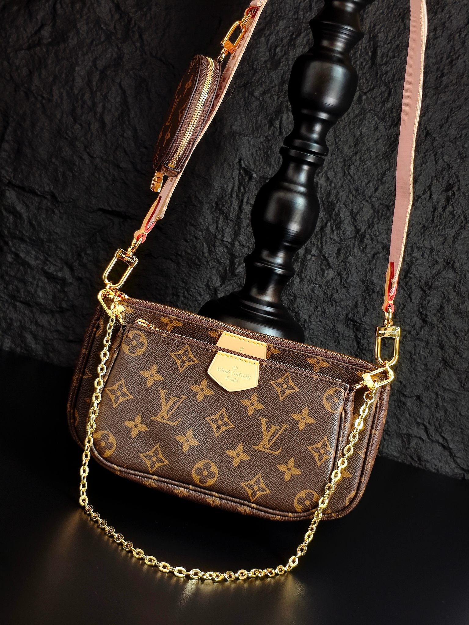 Louis Vuitton crossbody bag with monogram canvas, gold chain strap, and zippered front view