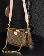 Louis Vuitton crossbody bag with monogram canvas, gold chain and pink strap, side profile