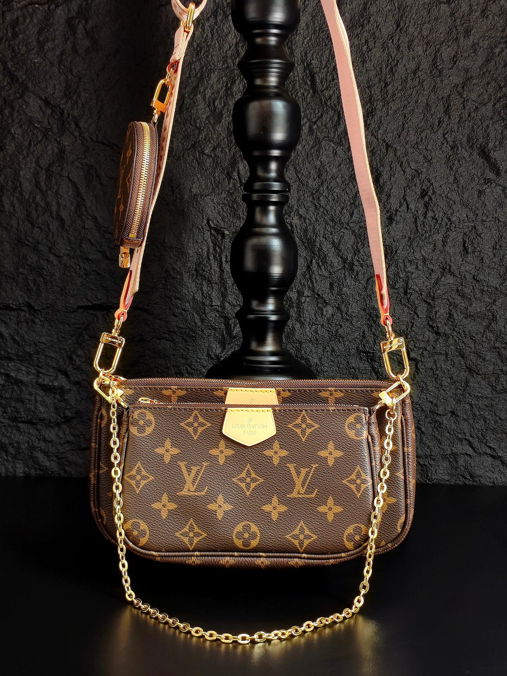 Louis Vuitton crossbody bag with monogram canvas, gold chain, and front flap pocket