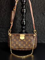 Louis Vuitton crossbody bag with monogram canvas, gold chain, and front flap pocket
