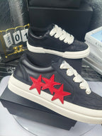 Navy low-top sneakers with white laces and red twin-star patch, white sole