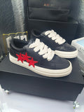 Navy low-top sneakers, white laces, red star applique, white rubber sole