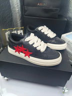 Navy low-top sneakers, white laces, red star applique, white rubber sole