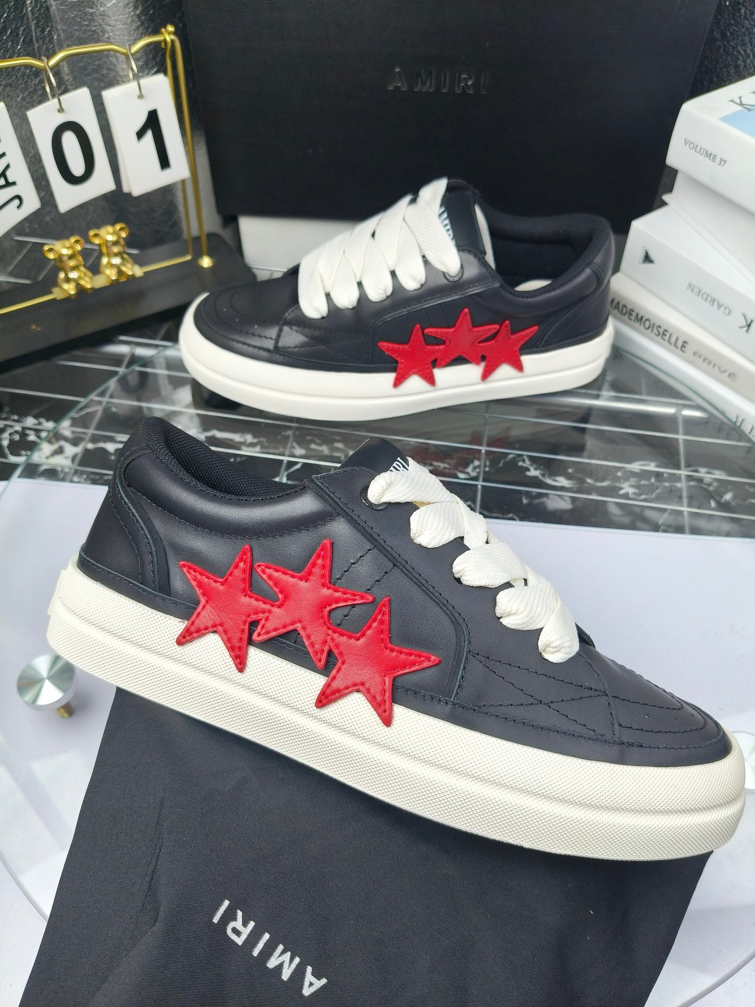 Navy low-top sneakers with white laces and red triple-star patch, white rubber sole