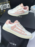Amiri low-top sneakers with white uppers and pink heel and side details, lace-up.