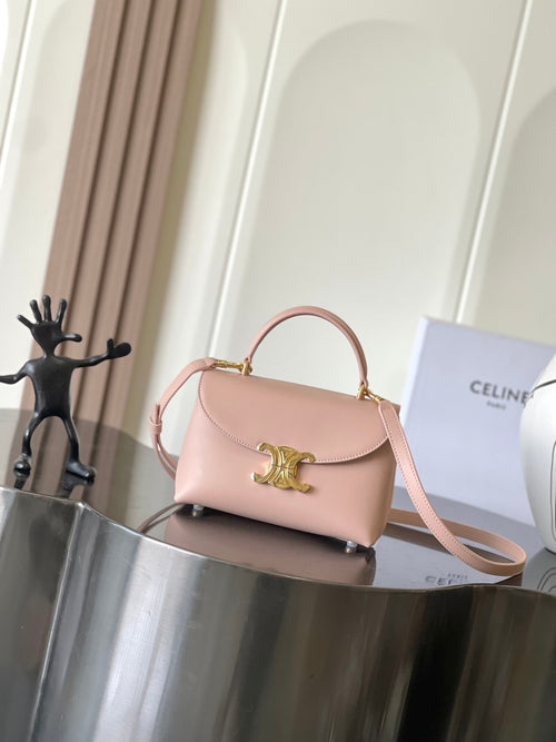 Celine mini handbag in pale pink with top handle and gold logo clasp