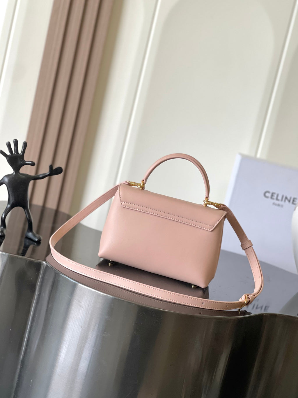 Celine mini handbag in pale pink with flap and gold-tone logo front