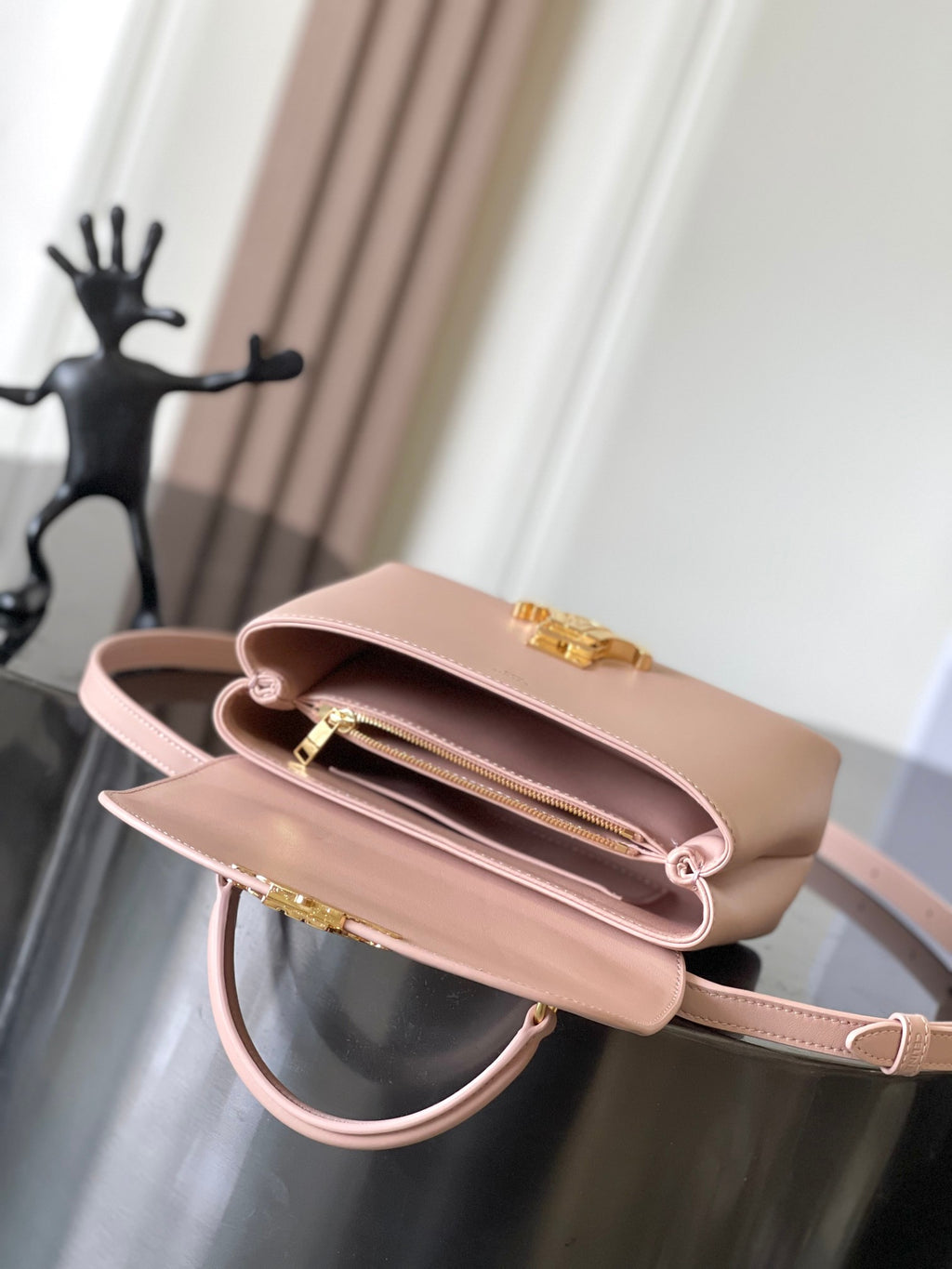 Celine mini handbag in pale pink, open top view with gold hardware and strap