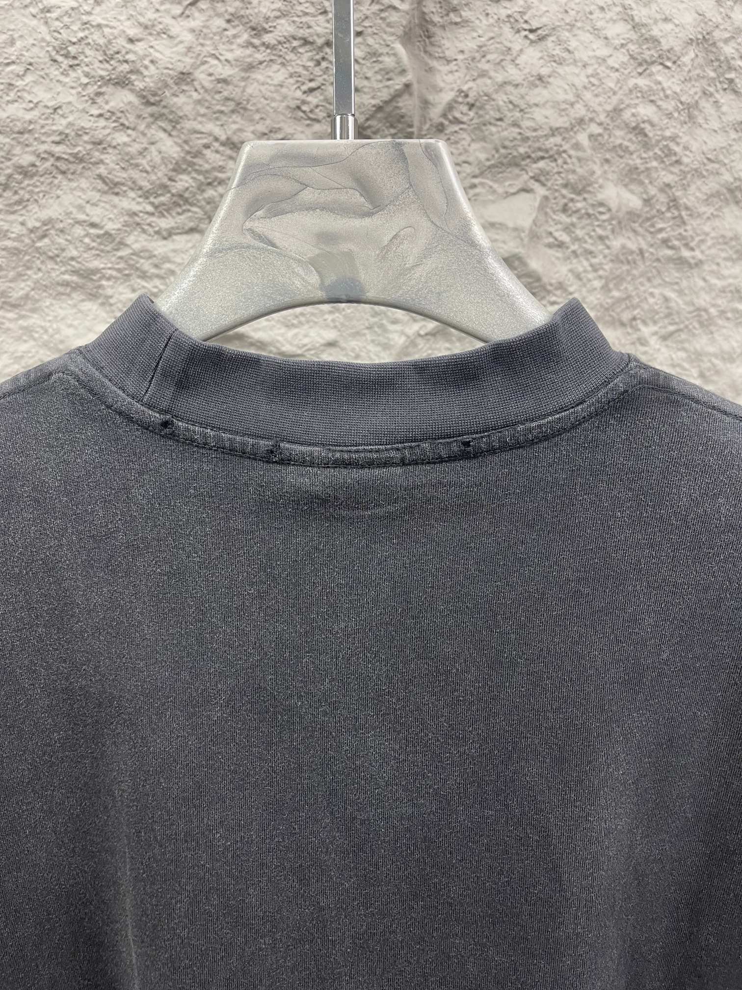 Balenciaga short-sleeve T-shirt neckline close-up, dark gray crew neck ribbing.