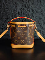 Louis Vuitton monogram bucket bag front view with top handle and shoulder strap