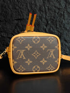 Louis Vuitton monogram mini crossbody bag with top tab detail and red tassel
