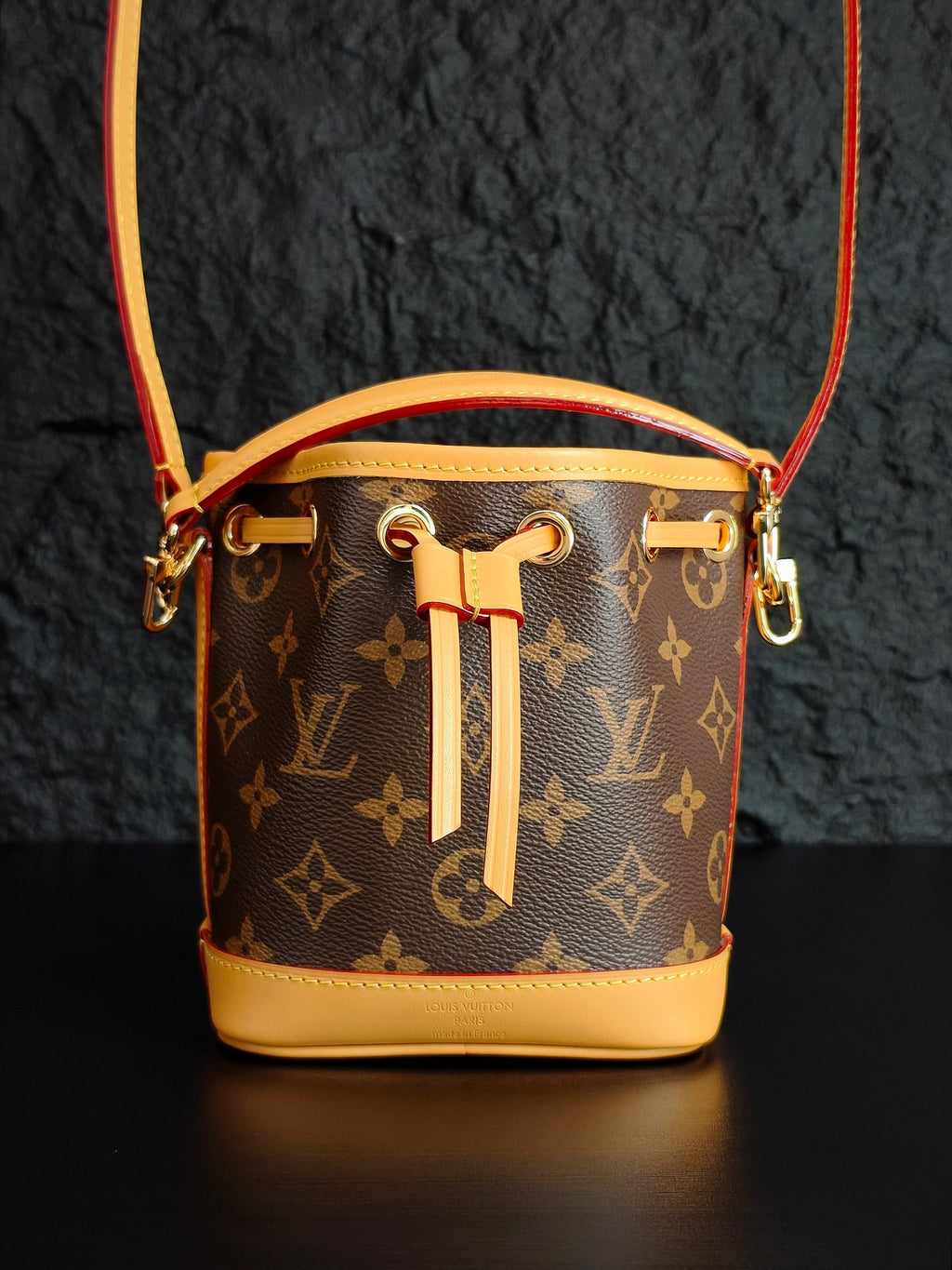 Louis Vuitton monogram bucket bag with gold-tone hardware and drawstring tassel
