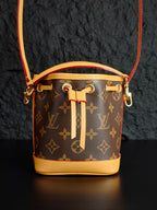 Louis Vuitton monogram bucket bag with gold-tone hardware and drawstring tassel
