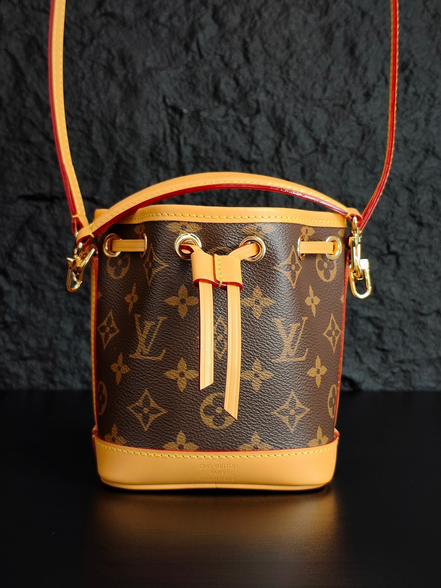 Louis Vuitton monogram bucket bag with gold-tone hardware and drawstring tassel