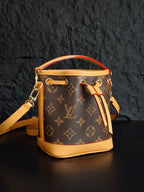 Louis Vuitton monogram bucket bag side view with handle rings and crossbody strap