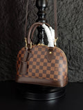 Louis Vuitton handbag in brown checkered canvas with top handles and fur trim
