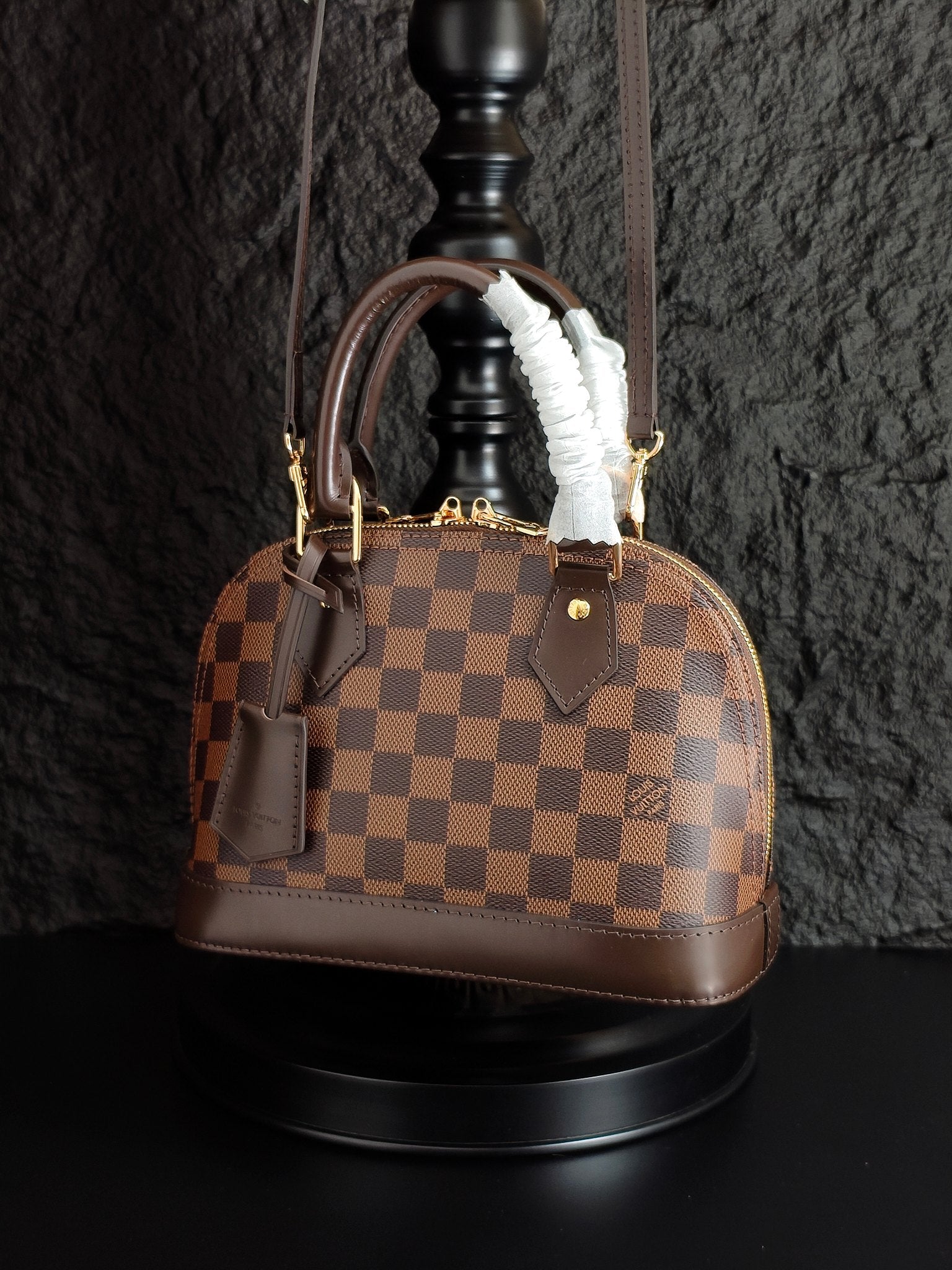 Louis Vuitton handbag in brown checkered canvas with top handles and fur trim