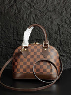 Louis Vuitton handbag with brown checkered pattern, top handles and round crossbody strap