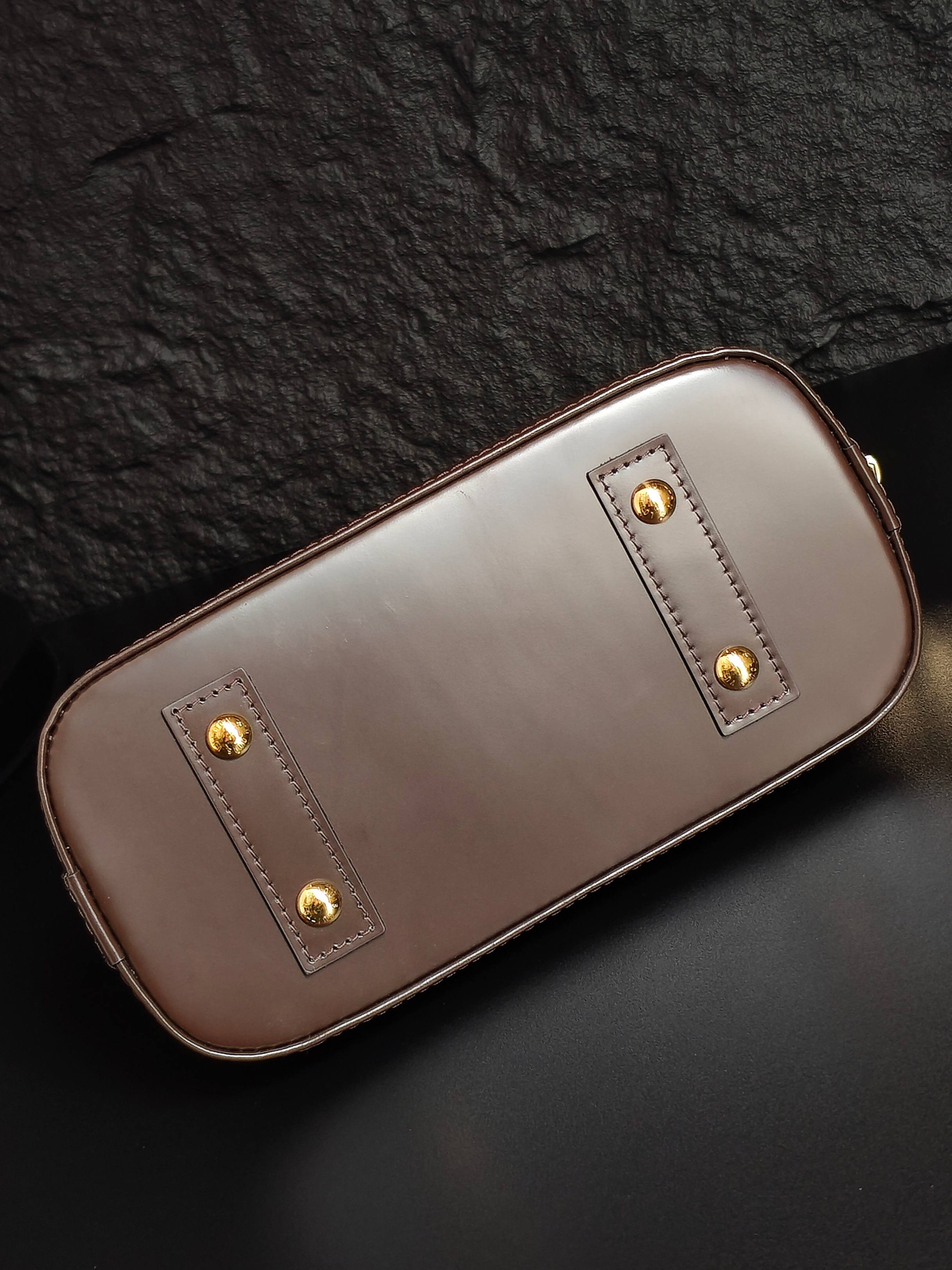 Louis Vuitton handbag in light taupe leather with gold stud details and top handle