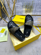 Black slide sandals with FF monogram straps and low platform sole