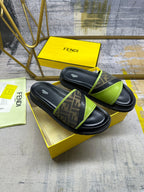 Fendi slide sandals on yellow box: black footbed with neon green strap and FF band