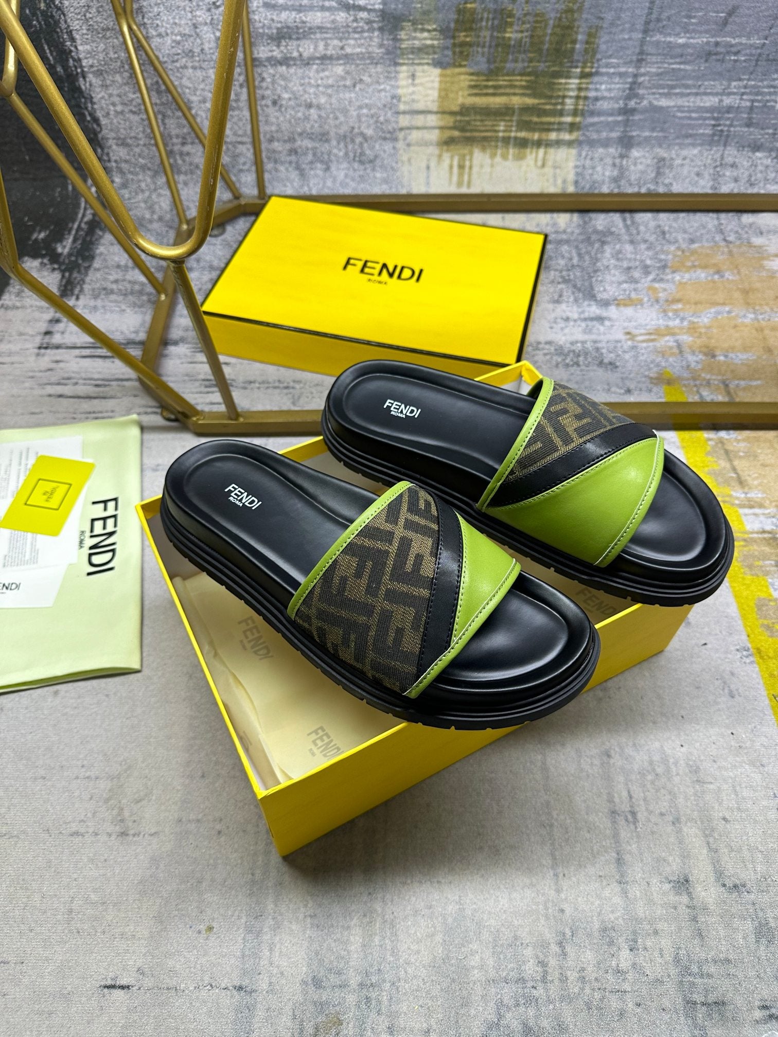 Fendi slide sandals on yellow box: black footbed with neon green strap and FF band