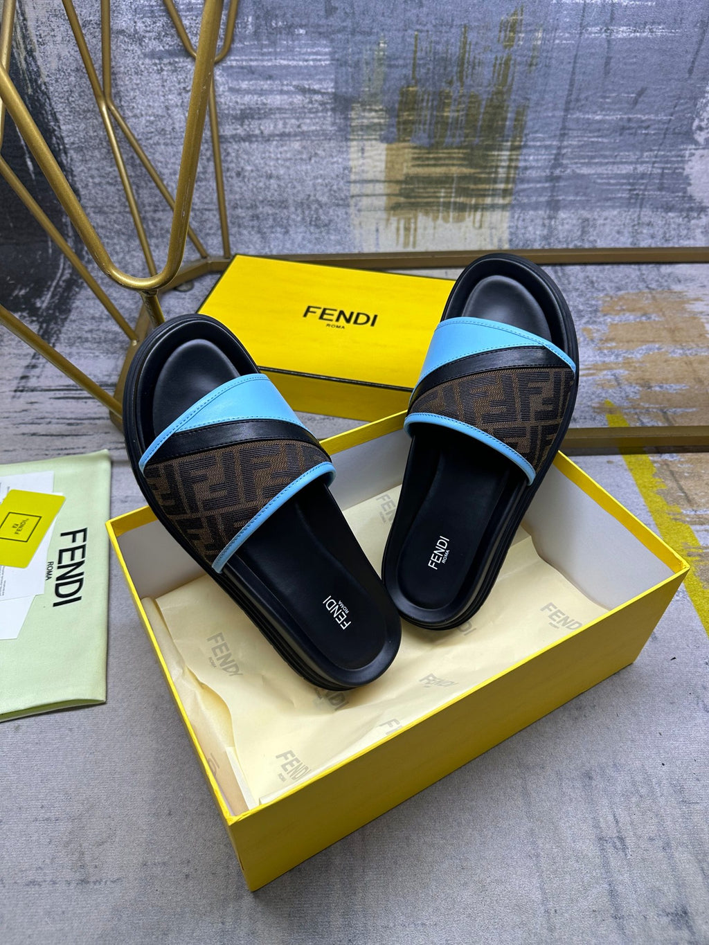 Fendi slide sandals on box, black and blue slides with FF logo strap