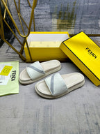 Fendi slide sandals, front view with white textured upper and light blue crossover strap
