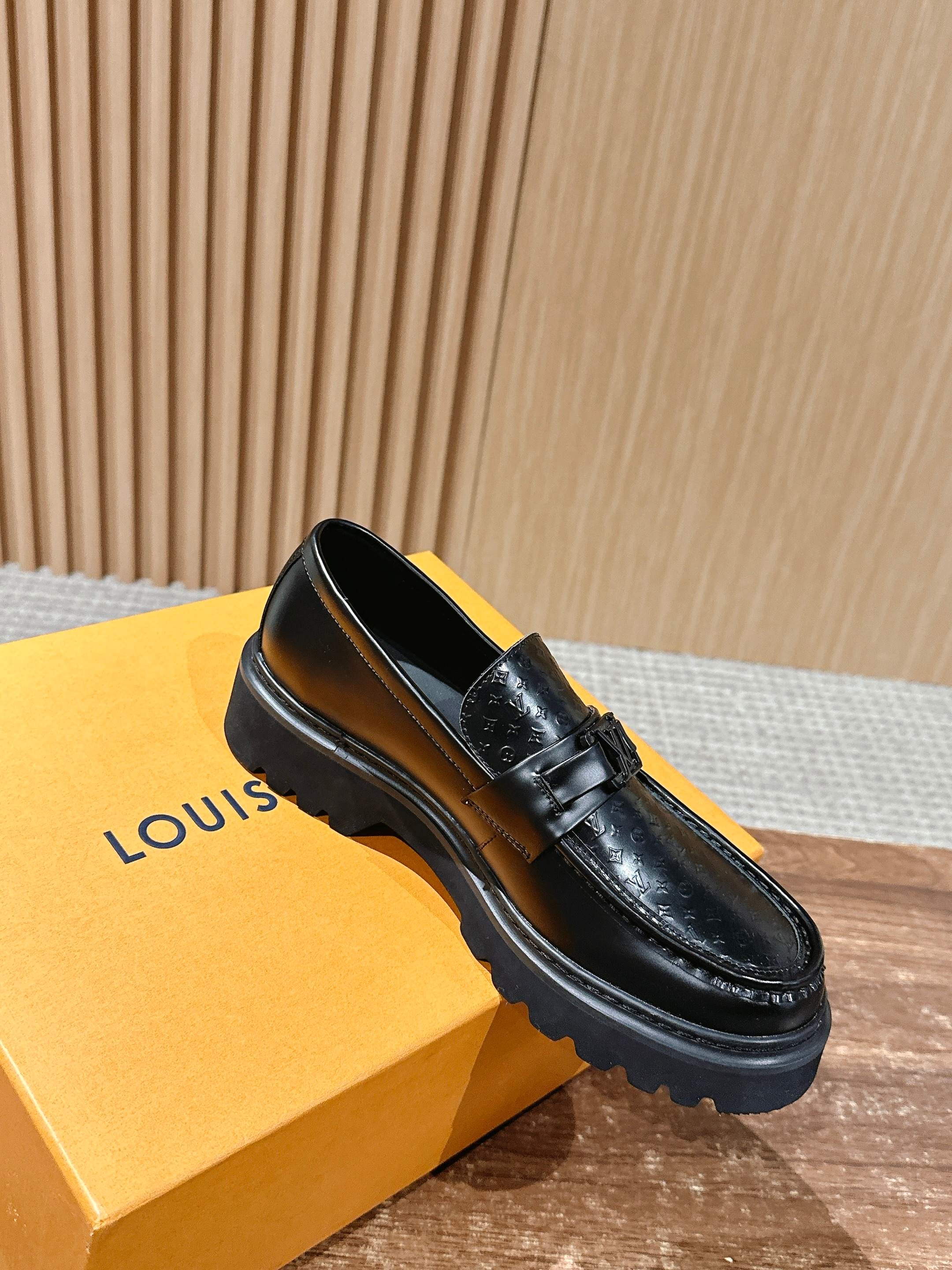 Black monogram leather loafer with chunky sole and single strap buckle