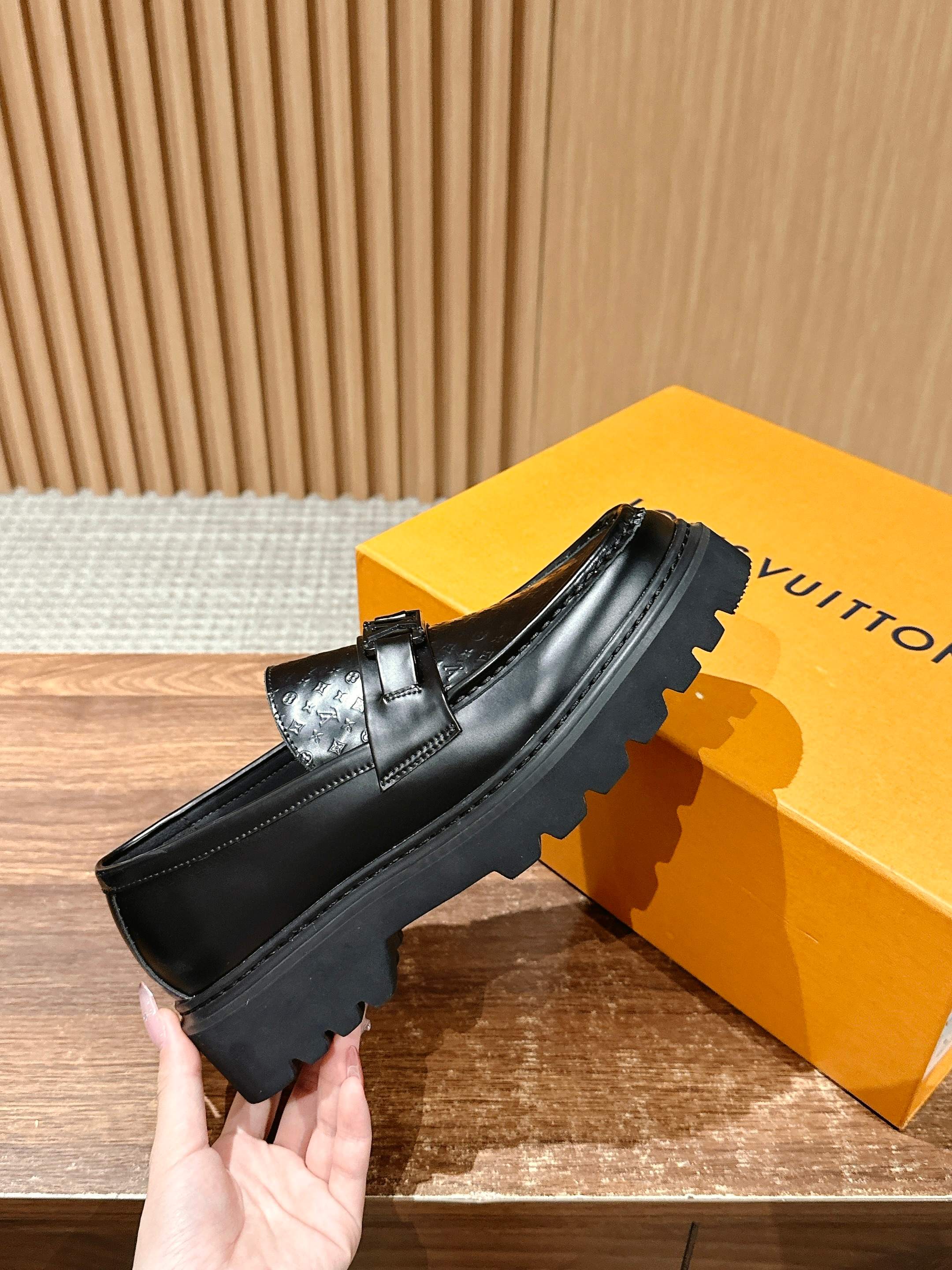 Black leather loafer with strap buckle and embossed monogram texture