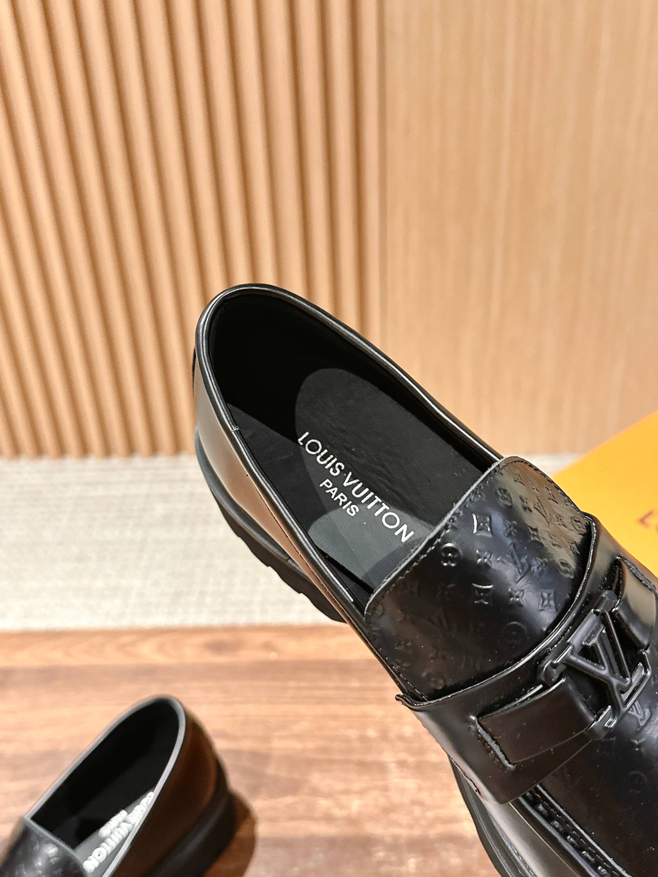 Black leather slip-on loafer with monogram interior lining and strap buckle