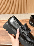 Black leather loafer with strap buckle and chunky sole edge detail