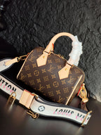 Brown monogram canvas handbag with cream leather straps and ruffled white handle cover